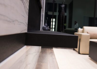 Modern interior featuring marble countertop, wooden flooring, and minimalist furniture.